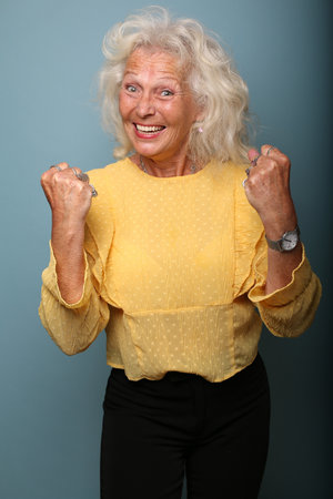 Portrait of a beautiful happy woman in front of a colored background