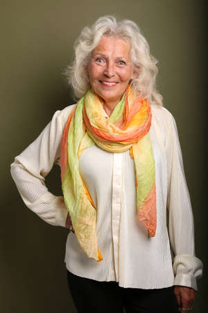 Portrait of a beautiful happy woman in front of a colored background