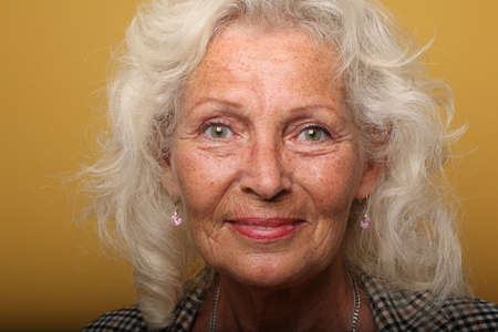 Portrait of a beautiful happy woman in front of a colored backgroundの写真素材