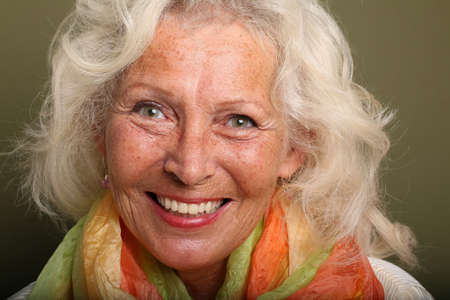 Portrait of a beautiful happy woman in front of a colored background