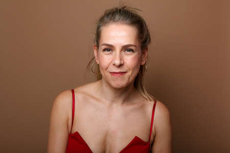 Portrait of a beautiful happy woman in front of a colored backgroundの写真素材