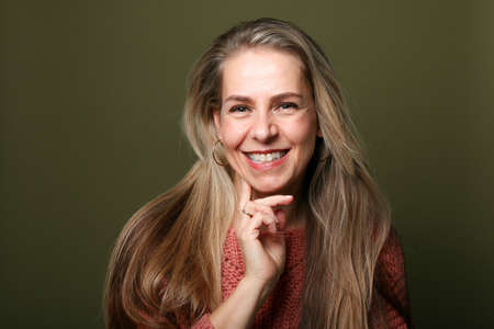 Portrait of a beautiful happy woman in front of a colored background