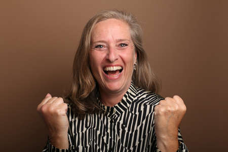 Portrait of a beautiful happy woman in front of a colored background