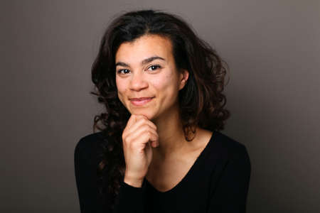 Portrait of a beautiful happy woman in front of a colored backgroundの写真素材