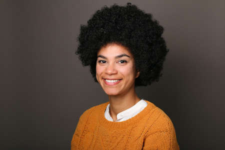 Portrait of a beautiful happy woman in front of a colored background