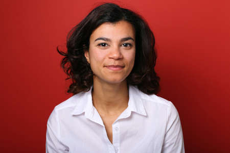 Portrait of a beautiful happy woman in front of a colored backgroundの写真素材