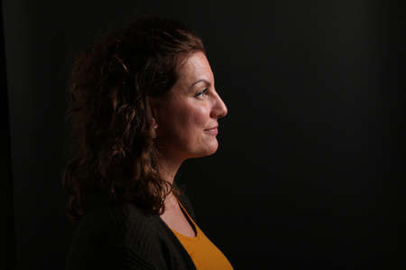 Portrait of a beautiful happy woman in front of a colored background