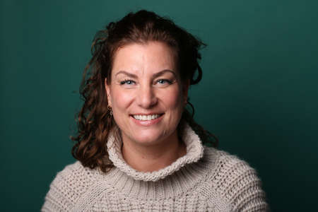 Portrait of a beautiful happy woman in front of a colored backgroundの写真素材