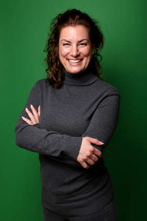 Portrait of a beautiful happy woman in front of a colored backgroundの写真素材