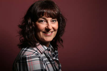 Portrait of a beautiful happy woman in front of a colored background