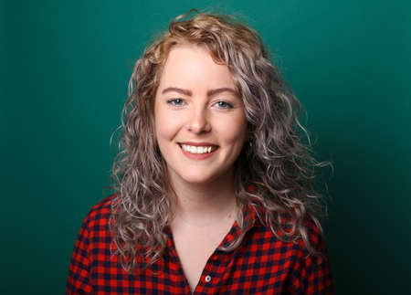 Portrait of a beautiful happy woman in front of a colored background
