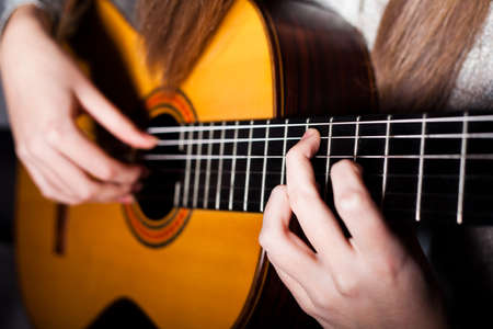 Woman playing acoustic guitar