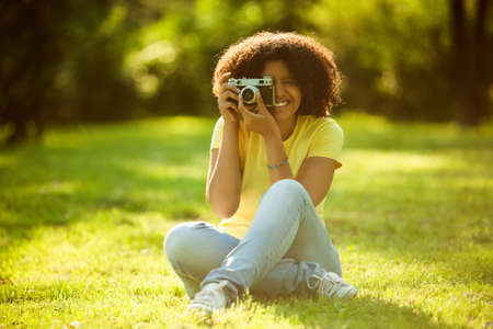 Young woman enjoying summer and photographingの写真素材