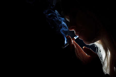 Silhouette of a cigarette smokerの写真素材