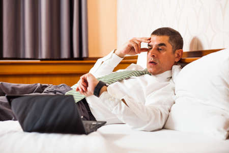 Businessman realizing that he is going to be lateの写真素材