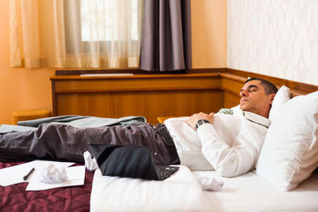 Tired businessman is sleepingの写真素材