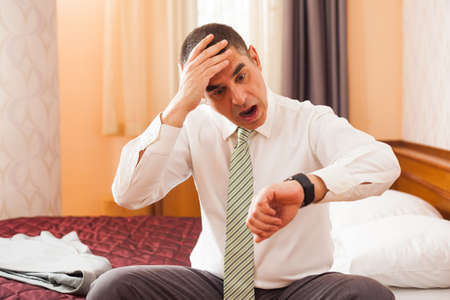 Businessman realizing that he is going to be lateの写真素材