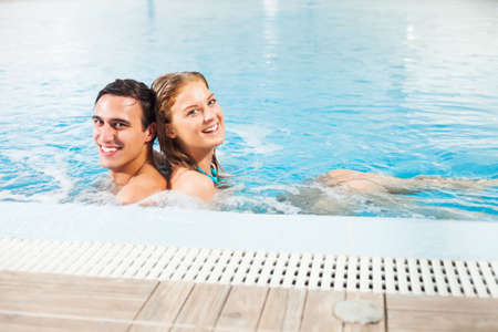Happy couple in swimming poolの写真素材