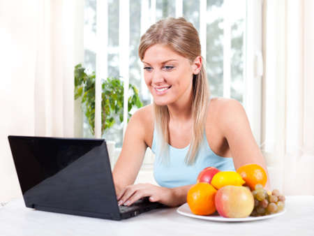 Woman using laptop at homeの写真素材