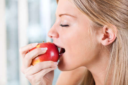 Woman eating an appleの写真素材