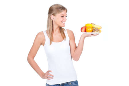 Woman holding a lot of fruit on the dish, isolated on whiteの写真素材