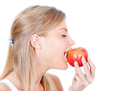 Woman eating an apple, isolated on whiteの写真素材