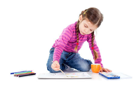 Little girl sitting on floor and drawingの写真素材