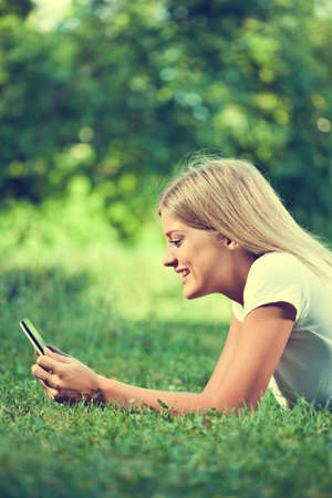 Woman using digital tablet, intentionally tonedの写真素材