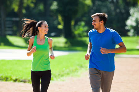 Happy couple jogging outdoorの写真素材