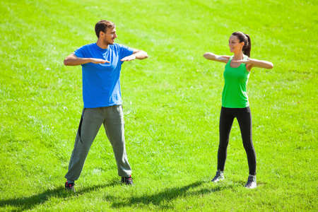 Young couple stretching bodies, warming up for joggingの写真素材