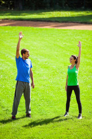 Young couple stretching bodies, warming up for joggingの写真素材