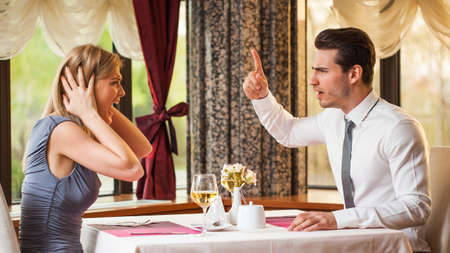 Young couple is arguing in restaurantの写真素材