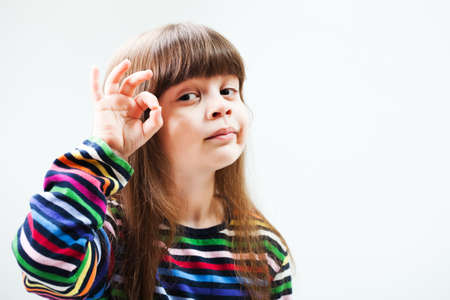 Little girl showing ok signの写真素材