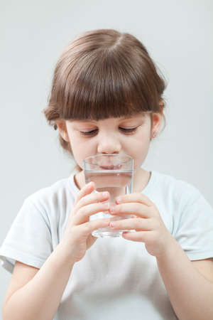 Little girl drinking waterの写真素材
