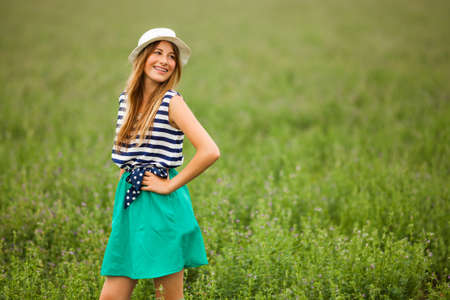 Portrait of happy girl in wheat fieldの写真素材