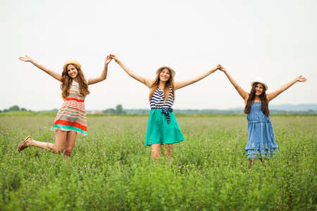 Happy girls smiling in wheat fieldの写真素材