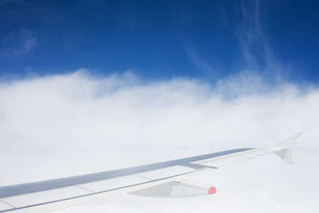 Air view of clouds, sky and airplane wingの写真素材
