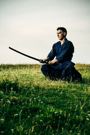 Kendo fighter holding bokuto, intentionally toned.の写真素材