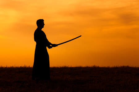 Silhouette of kendo fighter holding bokutoの写真素材
