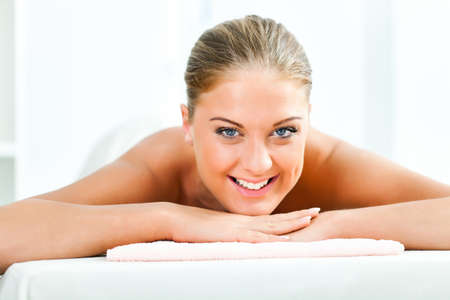 Young woman relaxing after massage on spa treatmentの写真素材