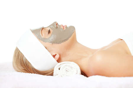 Young woman with clay skin mask on her faceの写真素材