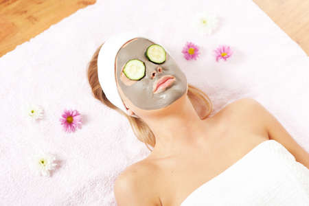 Young woman with clay skin mask on her faceの写真素材