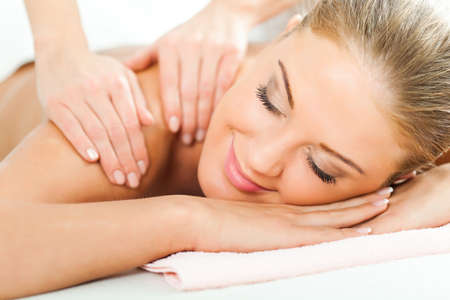 Young woman having neck massage on spa treatmentの写真素材