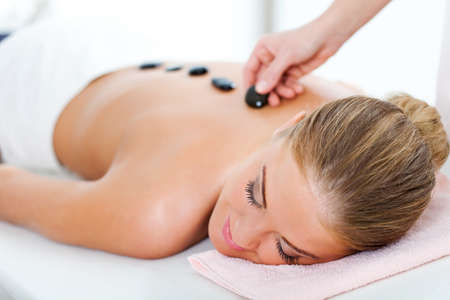 Young woman relaxing after massage on spa treatmentの写真素材