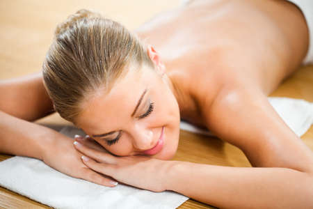 Young woman relaxing after massage on spa treatmentの写真素材