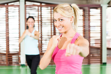 Two women exercising in gymの写真素材