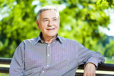 Portrait of happy senior man in parkの写真素材
