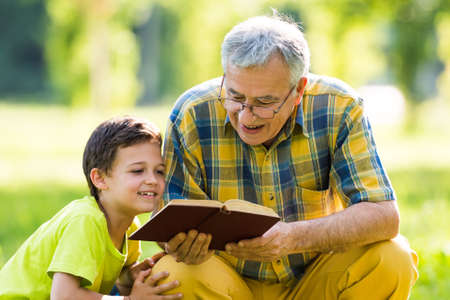Grandfather and grandson learning about natureの写真素材