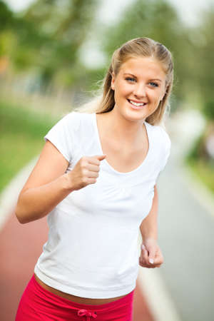 Happy young woman joggingの写真素材
