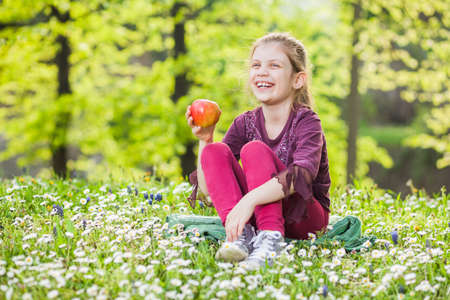 Happy child holding appleの写真素材